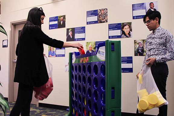 Photo by Cecilia Torres/The Runner Health educator Lauren Ash and Graduate Student Leader Jose Lopez start a game of Connect Four during the LGBTQ+ Pride Semester Welcome Back Game Social in the Multicultural Alliance Gender Equality Center, Thursday, Feb. 8, 2018.
