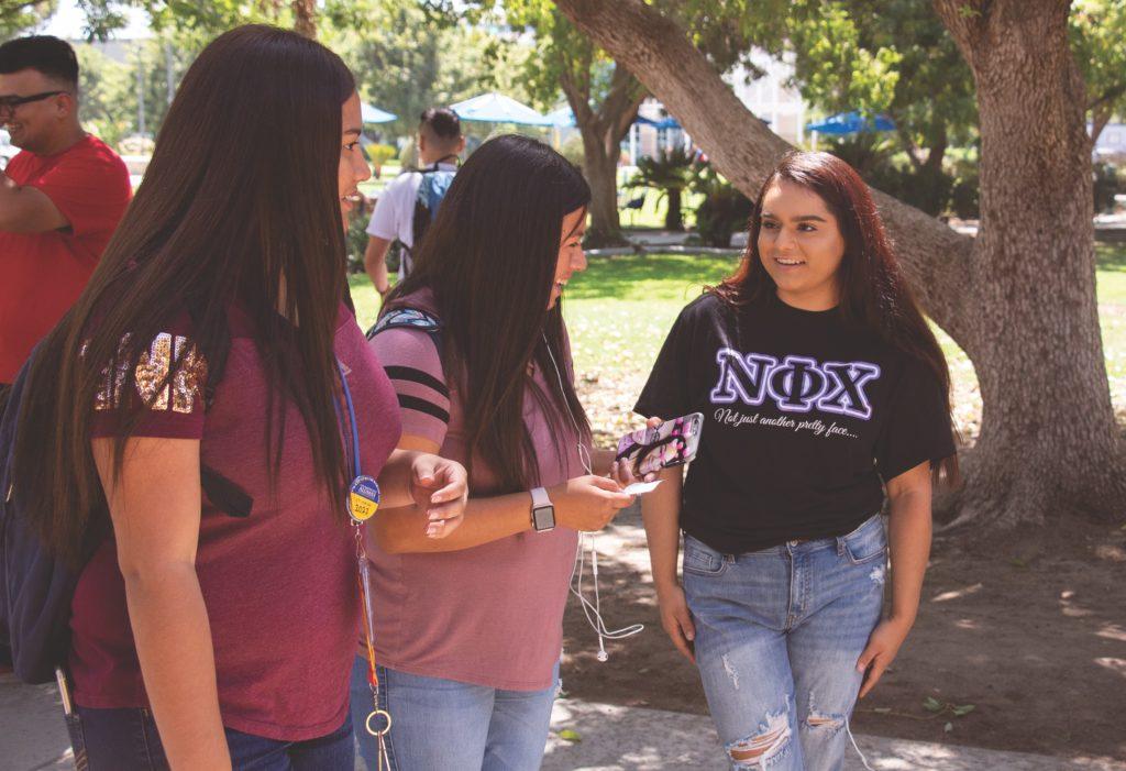 Arlene Medina, Publicity Chair for Nu Phi Chi Sorority talking to passing students about
recruitment and promoting Greek life and sisterhood. Aug. 27th, 2018 
Skylar Carrasco / The Runner