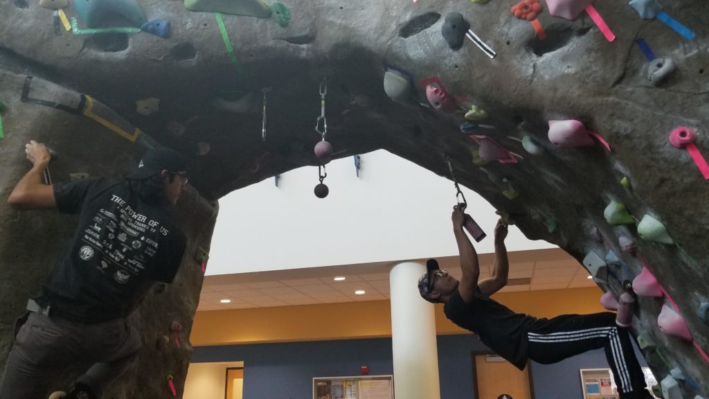Randy Arevalo and Trent Cardenas climb on The Rock at the Student Rec Center on Feb. 14 during the partner climb night.

Sam Underwood/The Runner