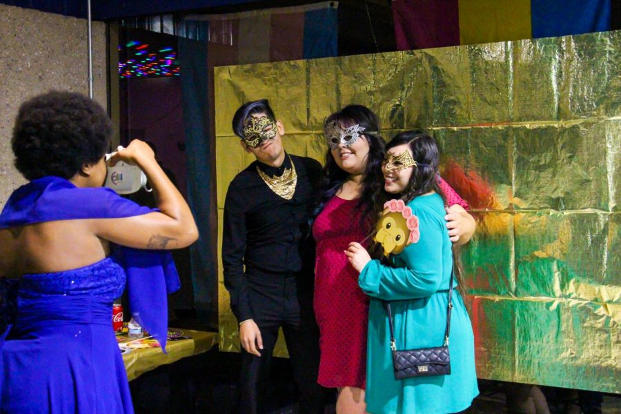 From left to right, Communications major Iyana Haggins, take polaroid snapshots of Educational Counseling majors Jose Lopez, Gabby Roland, Abigail Ramos during the MasQUEERade Ball in the Stockdale Room on Friday, March 29. Leo Garcia/The Runner