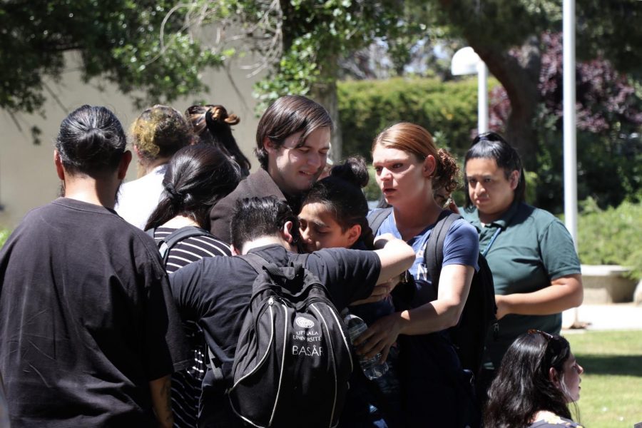 Sean Kelly (center), is comforted by fellow students during a Memorial Service for his late brother and CSU Bakersfield sophomore Jason Quinn Kelly on April 24. Kelly died on April 2.