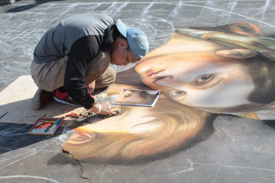 Artist, Shuji Nishimura, works on his piece based on Raphael’s Madonna della seggiola on Oct. 19, 2019 during day one of Via Arté at the Market Place.