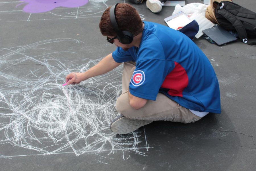 Local tattoo artist Jose Romero work on his piece on day one of Via Arté at the Market Place.
