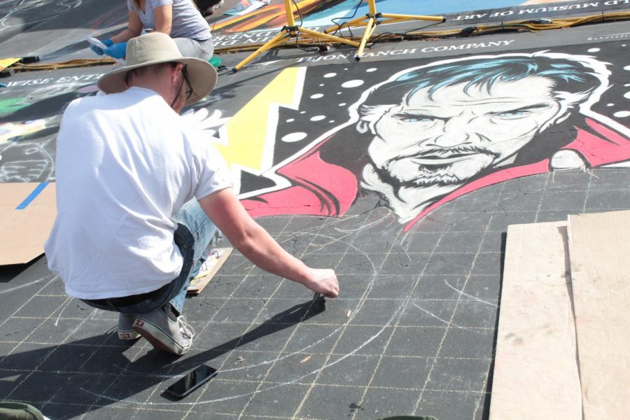 Artist, Jason Henderson, works on his chalk work of Doctor Strange on Day 1 of Via Arté at the Market Place.
