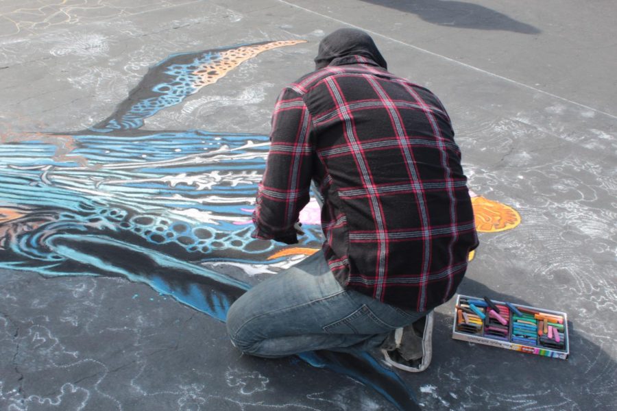 CSUB Alumni Francisco Holguin works on his piece based on the Hokuasai art movement on Day 1 of Via Arté at the Market Place. 