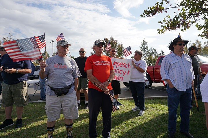 Community members gather to show their support for the current president at a pro Trump rally organized by Luther Craig on California Ave. Thursday Oct. 15