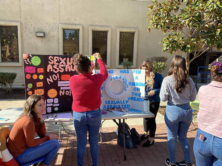 From left: Valeria Padilla and Jennifer Cano pictured setting up their poster to present to students. 