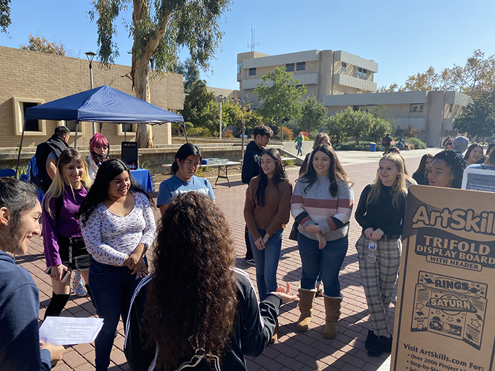 A group of students gather around to answer questions on how they can spot and/or prevent sex trafficking.