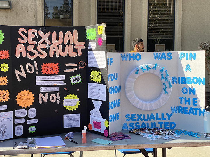 Valeria Padilla and Jennifer Cano (not pictured) presented a poster with the Sexual Assault topic. A wreath was also on their booth for students to place a pin if they knew/know someone who's been a victim of sexual assault. 