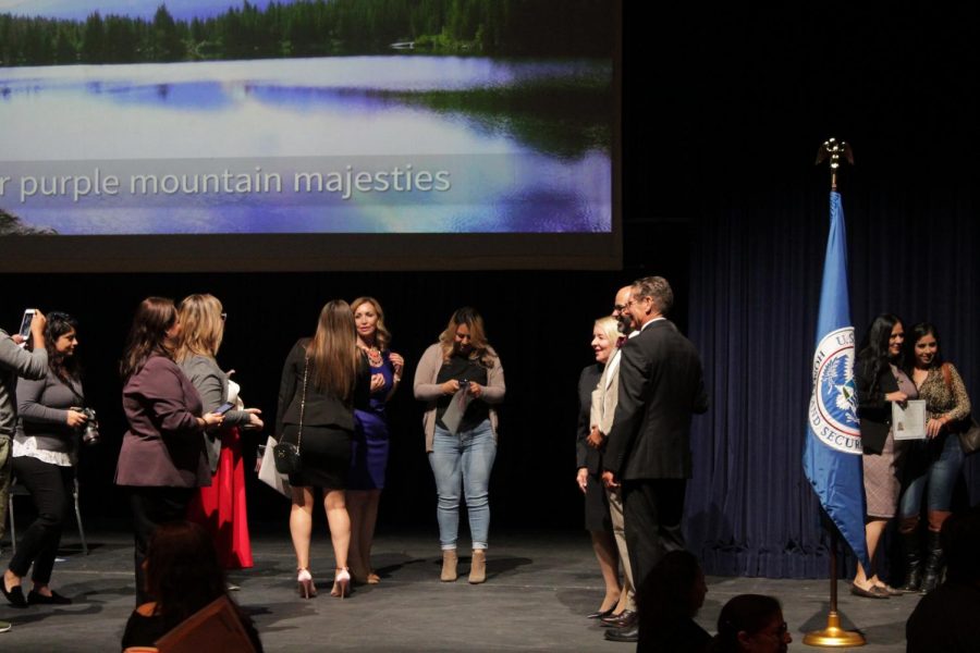 Families gather to celebrate and pose for pictures at the conclusion of the Naturalization Event on Nov. 12, 2019 inside the Dore Theatre.
