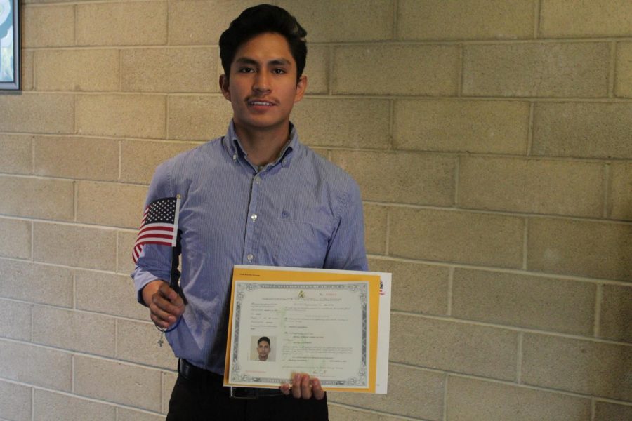 Former CSUB student, Israel Cardenas, poses with his certificate of citizenship after the Naturalization Ceremony inside the Dore Theatre on Nov. 12, 2019. 