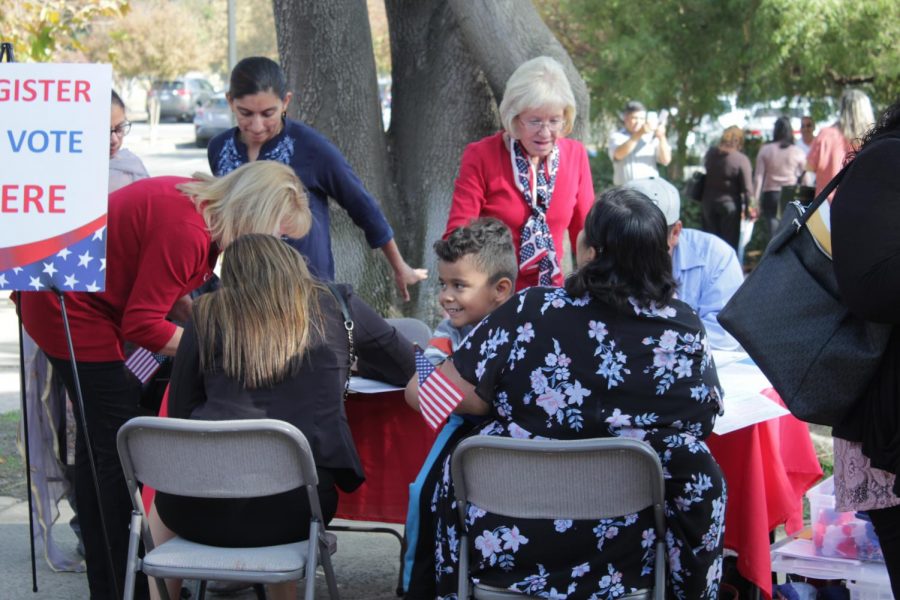 Newly naturalized citizens register to vote after the Naturalization Ceremony in the Dore Theatre on Nov. 12, 2019. 
