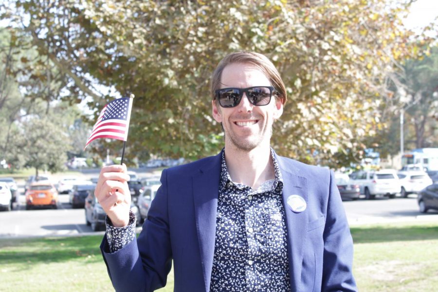 American Citizen, Simon Moore, poses with an American flag immediately after being naturalized inside the Dore Theatre during the Naturalization Event on Nov. 12, 2019.