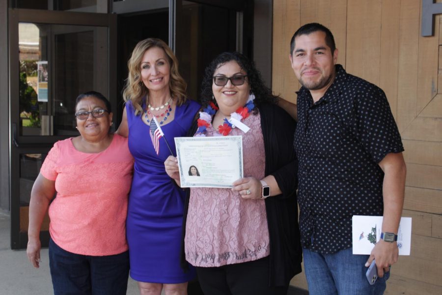 Valley citizen Alma Fuentes along with her family pose proudly with her certificate of citizenship after the naturalization ceremony in the Dore Theatre on Nov. 12, 2019. 