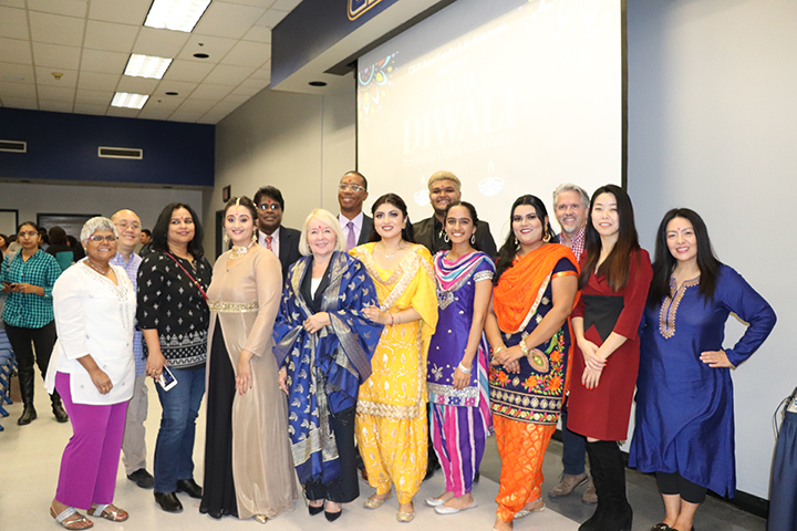 From left: Lisa Zuzarte, Charles Lam, Sumita Sarma, Mitali Sharma, Kris Krishnan, President Lynnette Zelezny, Dr. Provost Harper, Henna Singh, Divyang Motavar, Jasleen Mander, Yaddeep Kaur Gill, Pierre Igoa, Jun-Yang Mao, and Sonia Silva gathered together after the Diwali festival to take a group picture.  