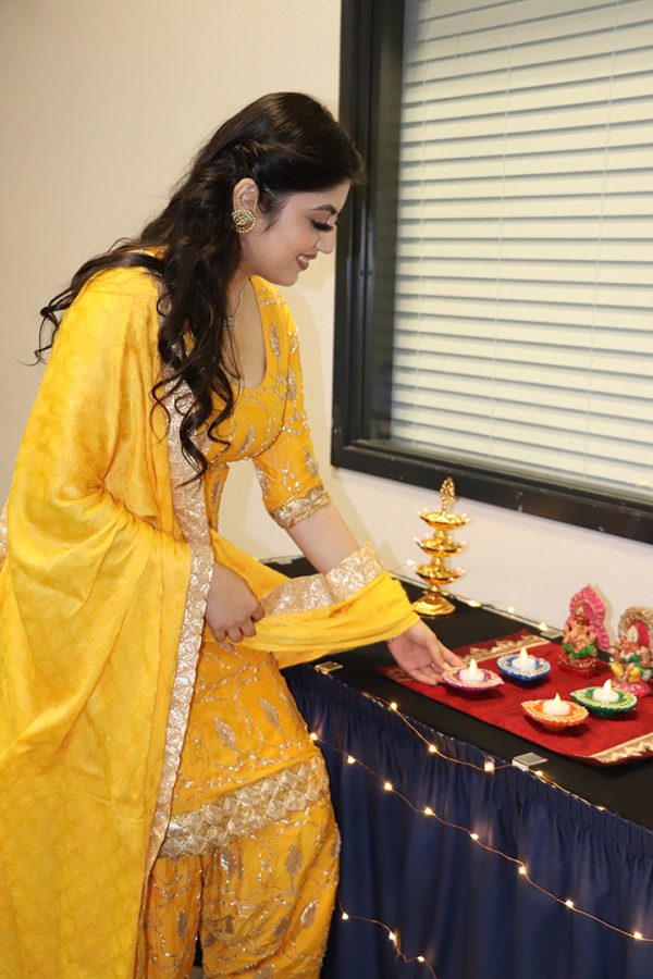 Henna Singh is pictured setting down the Diya candle during the Diwali festival. The Diya is typically lit during special holidays and events such as Diwali. 