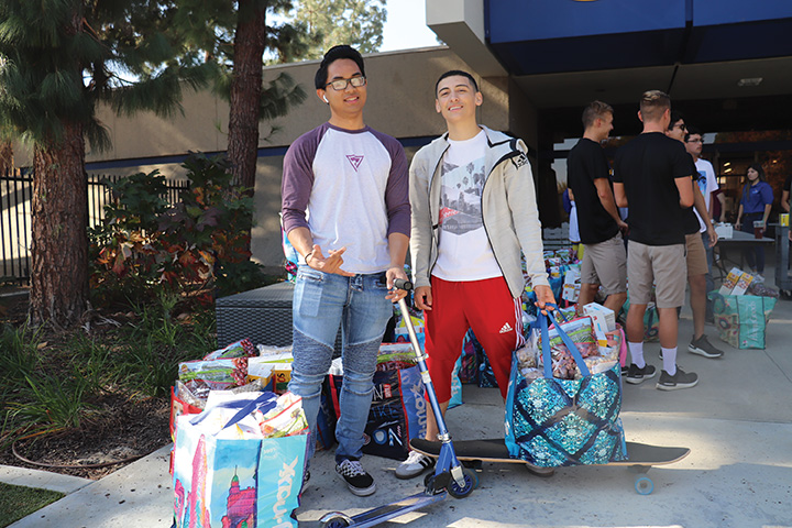 Jorge Moreno (right) and Trent Cardenas (left), were a few of many students who participated in the food distribution at the stockdale court on Nov. 18, 2019.