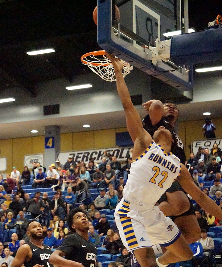 Freshman guard Justin McCall tries for a basket as GCU player defends during basketball game Sat. Jan. 4 at Icardo Center