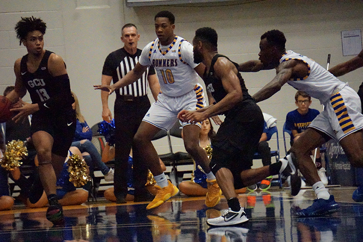 Junior Justin Edler-Davis and junior Taze Moore provide defenseagainst Grand Canyon during basketball game Sat. Jan. 4 at Icardo Center