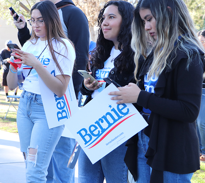 CSUB students, Samantha Rojas, Cindy Perrusquia, and Areli Lopez, using their phones to sign up to volunteer for Bernie’s California State Wide Call at the Bernie Sanders campaign rally held at CSUB on Feb. 12, 2020.  