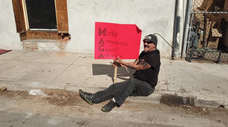 Andrew Gonzales, 70, a boxing coach and lifelong Bakersfield resident, participates in a protest before the arrival of President Trump. Gonzales says he protests because he is concerned by the divisions he's seen growing in society, and wants Americans to be better friends to one another. 
