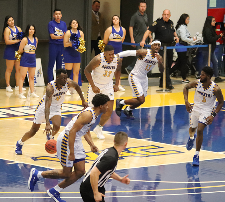 Redshirt junior guard Taze Moore leading the offense up court during the Homecoming Basketball game at the Icardo Center on Feb. 29