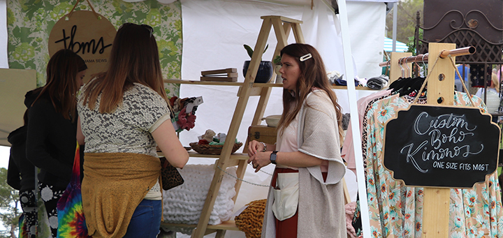 Ashley Archuleta, owner of This Boy Mama Sews, inside of her clothing booth selling her handmade items at the Rusty Roots Show held on camps March 7th.  