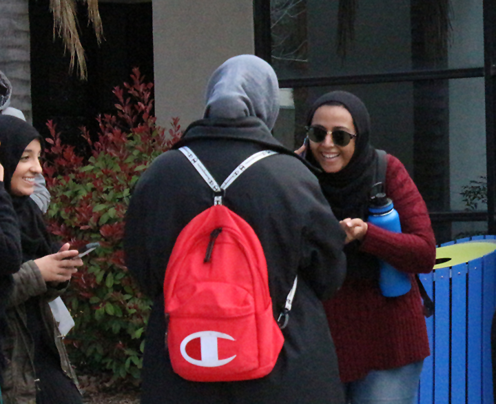 CSUB student Malah Alkorin on the phone with her cousin, CSUB student Ahlam Alawig, spreading the news that T-Pain was announced at the Runner Nights featured artist reveal at the Student Union Patio on March 10, 2020.  
