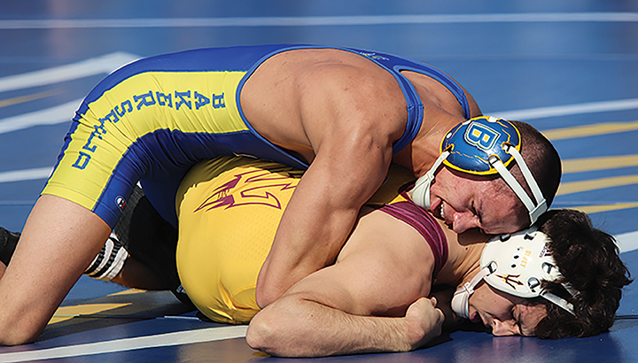 Senior Russell Rohlfing pins wrestler from Arizona State during the feud on the field happening on Sunday Feb. 16. 
