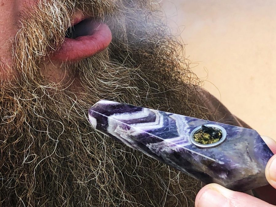 A marijuana consumer exhales smoke on April 20.