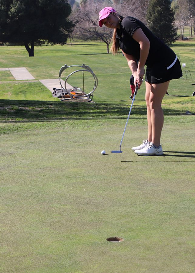 Senior Brandi Borjon practices putting at the Rio Bravo Country Club on Feb. 14.
