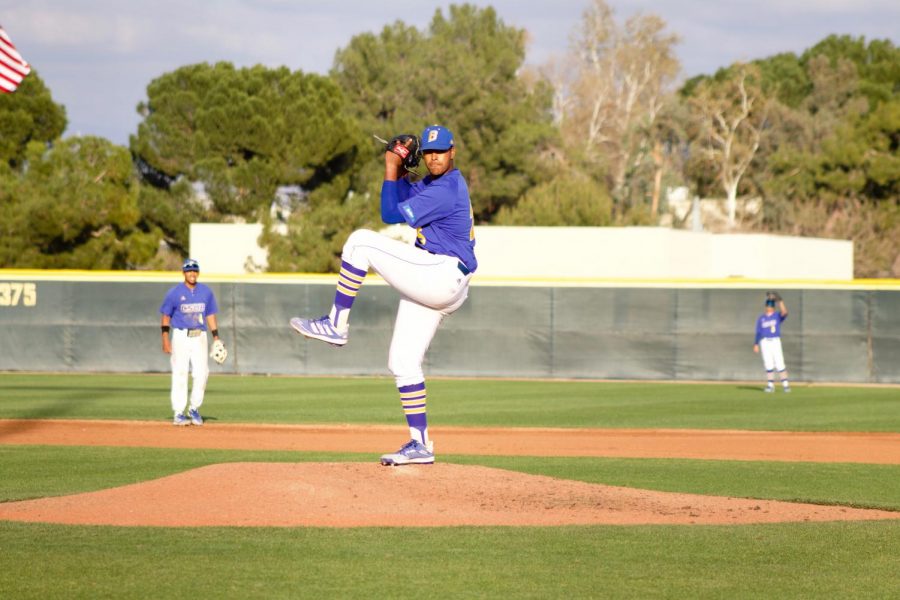 Pitcher Aaron Charles winds up to put the ball into play on March 6, 2021. Photo taken by Ellen Kommel/The Runner