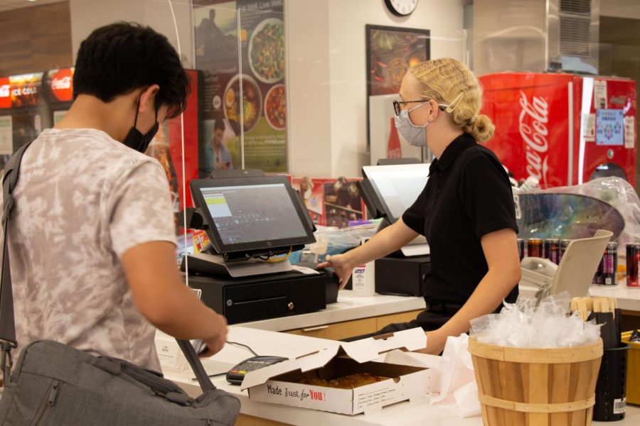 CSU, Bakersfield Runner Café employee, Nancy Smith, helps student purchase pizza. Wednesday, September 1, 2021.