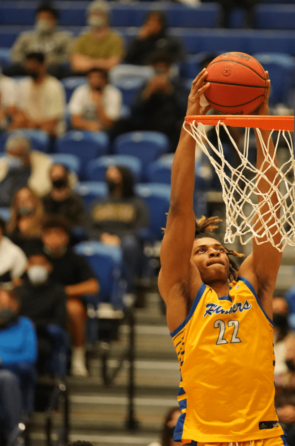 Senior Gaurd/Forward Justin Mccall elevates for a showstopping dunk.