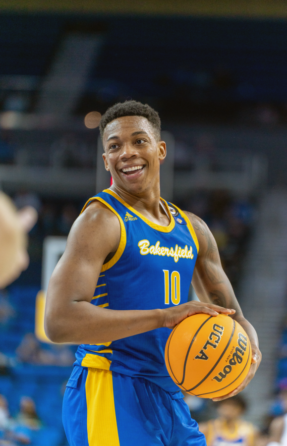 CSUB guard Justin Edler-Davis enjoys the company of his teammates in between possessions against the UCLA Bruins. Edler-Davis finished the game with 3 points, 2 rebounds, and 1 steal.  