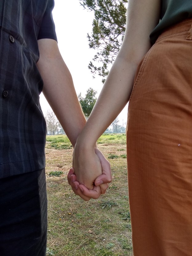 Photography that focuses on a couple holding hands.