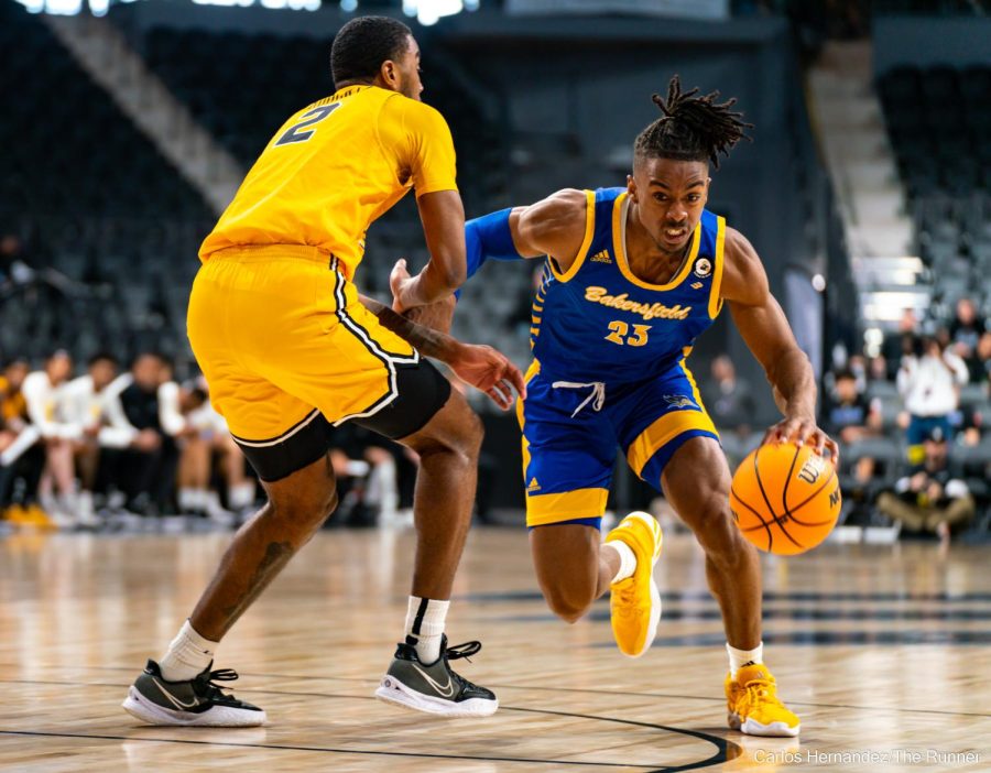 CSUB's Ivan Reynolds Drives against LBSU forward and Bakersfield native Jordan Roberts in hopes of bringing the 'Runners back from their deficit.
