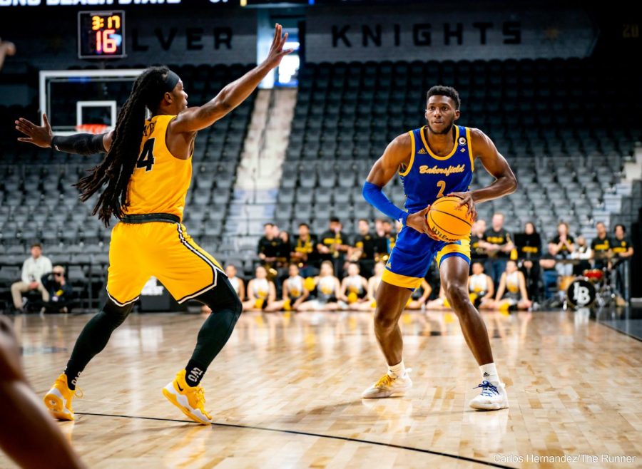CSUB's Travis Henson moves the ball around the perimeter in search of a hole within LBSU's defense.
