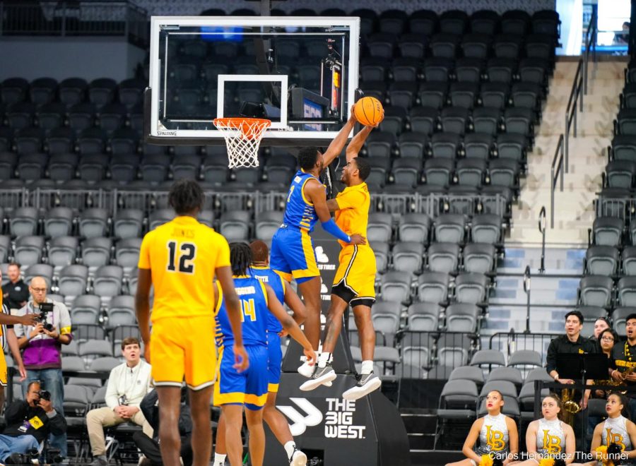 CSUB's Travis Henson gets a clean block up top against LBSU's Jordan Roberts, but the game official promptly rules the play a foul due to the body contact.
