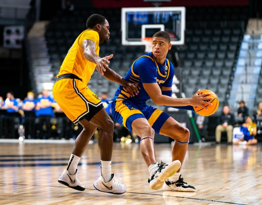 CSUB's Cameron Smith delivers an entry pass to the post as CSUB targets points in the paint.
