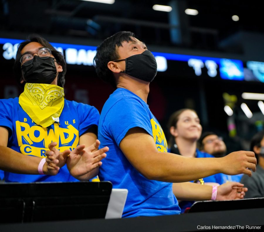 Aaron Bounthong, a senior Psychology major,  Big Blue Rowdy Crew member, and 2022 inaugural Lloyd Norwood Spirit Award winner keeps up the crowd's energy  with his bandmates amid timeout.
