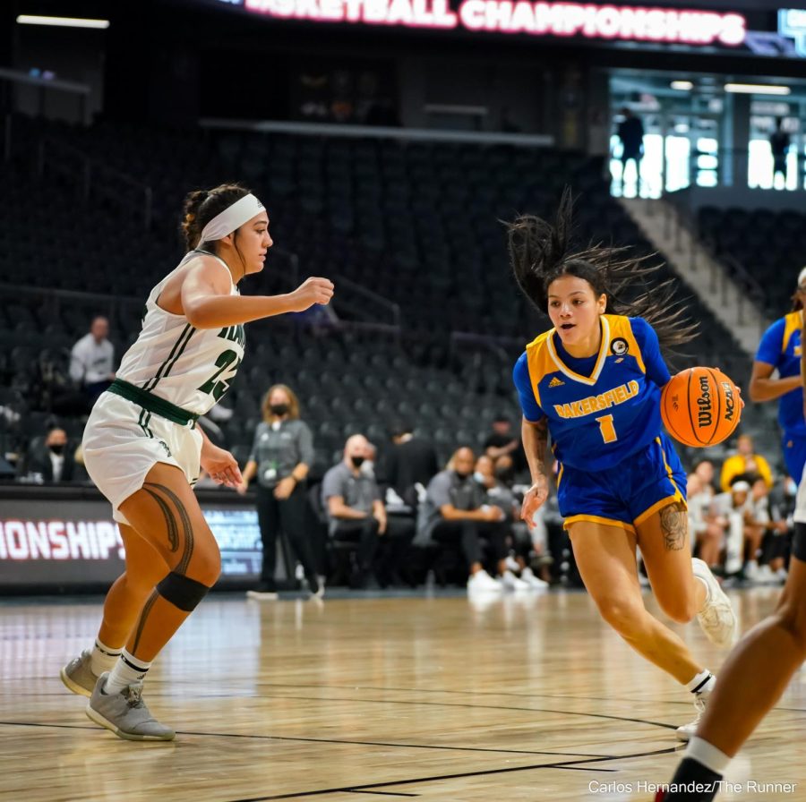 CSUB's TATYANNA CLAYBURNE crosses over Hawaii's MEILANI MCBEE.
