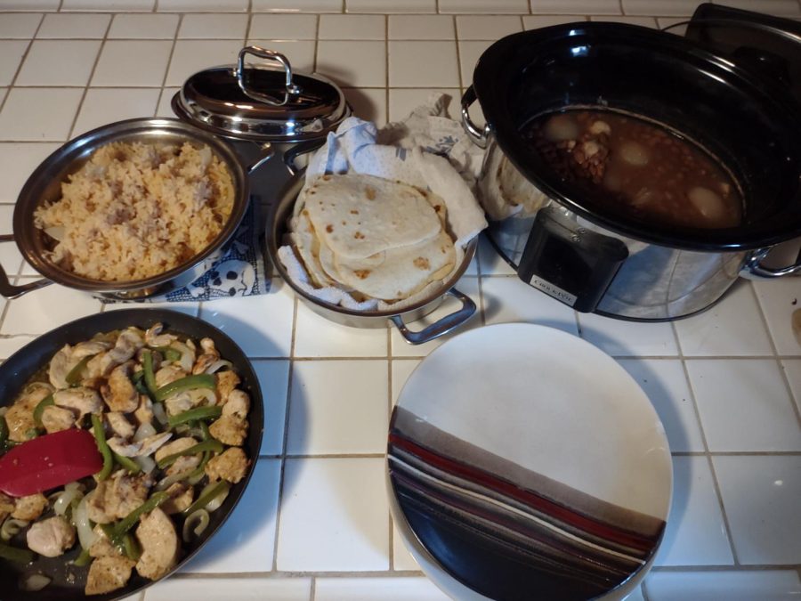 Rice, beans, tortillas and fajitas are ready for plating.