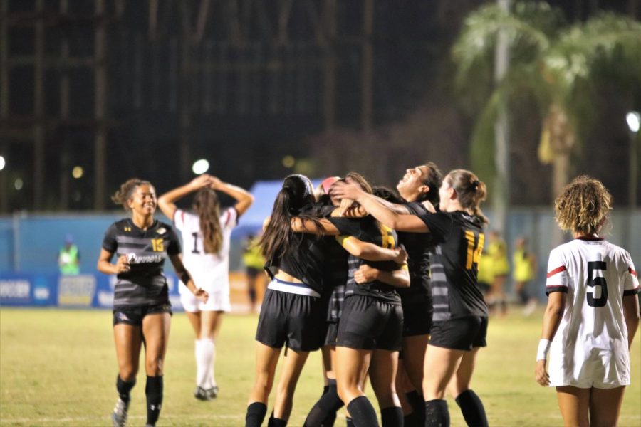 The 'Runners embrace in a group celebration from a goal by Kalea Eichenberger at The Main Soccer Field on Thursday, Sept. 15, 2022. 