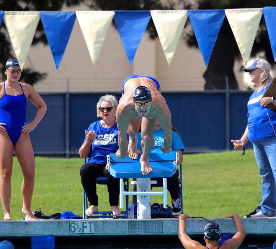 Antonio Milin at the starting block of the 100 yard breaststroke before winning the event with a time of 58.54 at the Hillman Aquatic Center on Saturday, Oct. 22, 2022. 