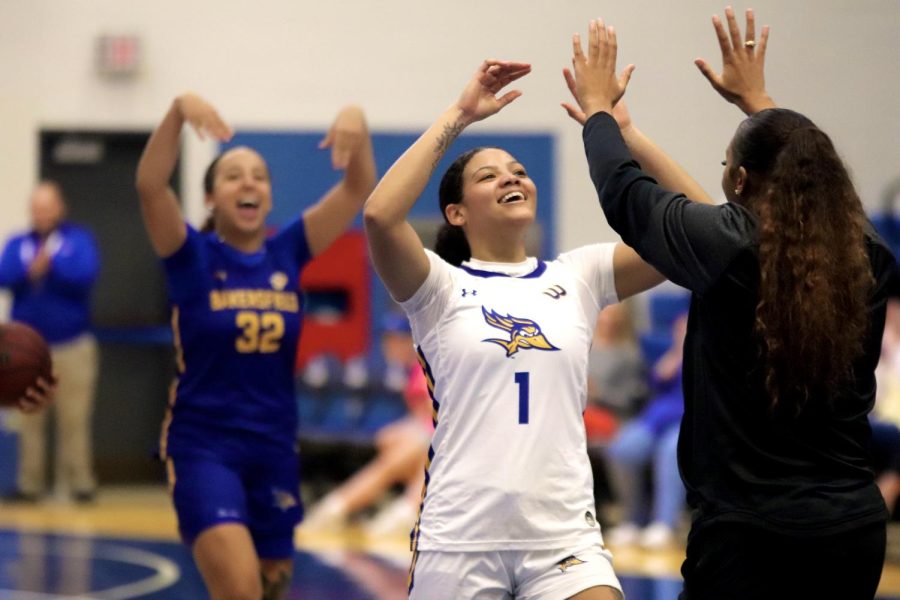 Coach Ciarra Ford congratulates Tatyanna Clayburne on winning the three-point shooting contest on Tuesday, Oct. 25, 2022, in the Icardo Center. 