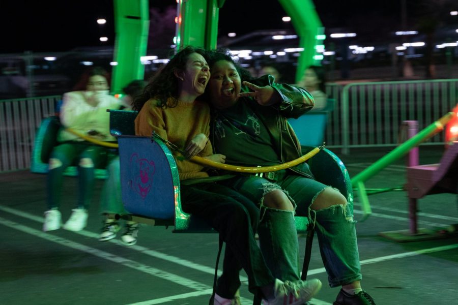 Students enjoying themselves on the swing carousel. 