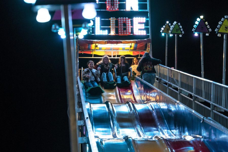 Students push themselves off the Fun Slide. Photo by Ranara Lim / The Runner