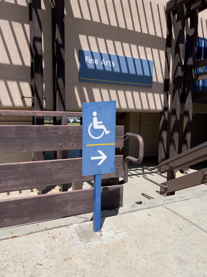 A sign next to the stairs under the Fine Arts Building that points to a ramp for those who cannot take the stairs. Photo by Ranara Lim / The Runner