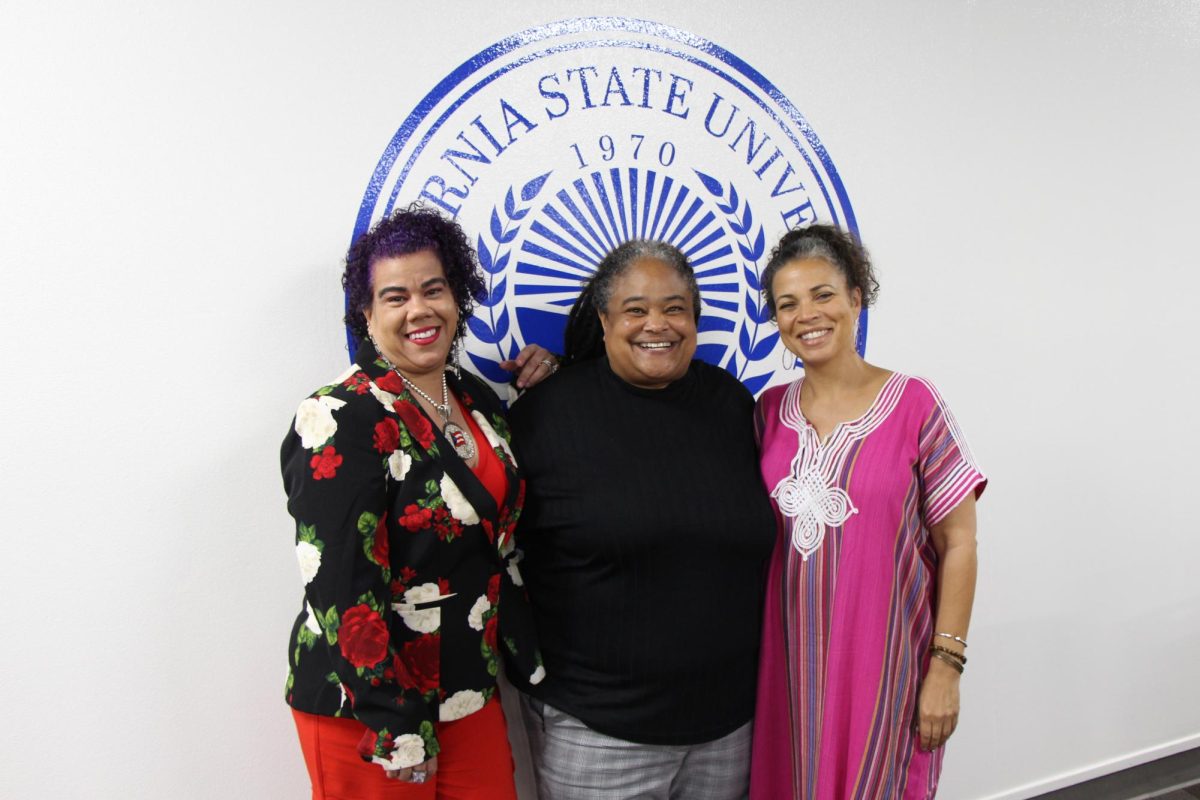 Rosa Clemente, Dr. Salisbury, Dr. Abdullah taking a photo in the Stockdale Room. 